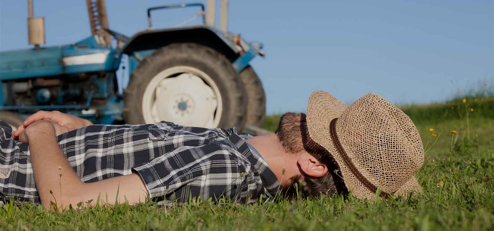 Farmer resting by a tractor